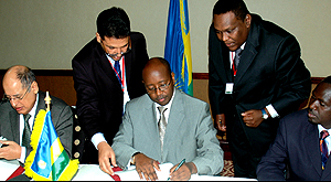 Arab Bank for Economic Development in Africa (BADEA)u2019s Ahmed Abdallah Al-Akeil (left) and Minister James Musoni sign an agreement at Kigali Serena Hotel yesterday. (Photo/G. Mbanda)