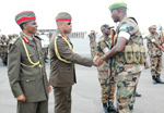 WELCOME BACK: Maj. Gen. Patrick Nyamvumba (C) greets Lt. Col. James Safari who lead the 14th batallion that returned from Darfur yesterday. Left is Brig. Gen. Jack Nziza.(Photo / J. Mbanda)