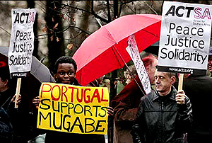 Pro-Mugabe supporters displaying placards on the streets of Lisbon, Portugal (Getty Images)