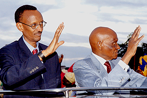 Presidents Kagame and Wade wave to crowds en route from Dakar airport on Wednesday. (PPU photo)
