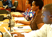 MPs Elysee Bisengiman, Connie Bwiza Sekamana and Thaciene Dusabeyezu casting their votes electronically yesterday as the Lower House voted to pass the 2008 budget. (Photo/ G. Barya)