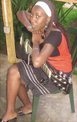 Doreen passionately holds the guitar she loves to play