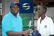 BCRu2019s CEO David Kuwana hands over a mug to 14-year-old Thierry Ntaganda.He has been tipped to be one of Rwandau2019s golf stars in the near future.  (Photo / M. Mazimpaka)