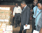 Minister Vincent Karega (center) inspects goods in a bonded warehouse.