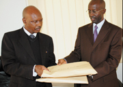 Rutayisire (right) hands over the examination results to Murekeraho yesterday. (Photo/ J. Mbanda)