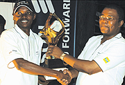 YELLO TIME: Fraterne Rubangura (L) receives the 2008 MTNEricsson Open trophy at Kigali Golf Club (Photo/ G. Barya)