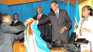 President Kagame hands over the EAC flag to Dr Anastase Shyaka, while L-R, Senate President Dr Vincent Biruta, Dr Murigande and Ms Beatrice Kiraso look on. This was after the launch of nationwide consultations on the EA Political Federation at Parliament