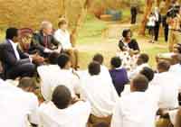 President Bush and his wife, Laura, during a visit to Lycu00e9e de Kigali last month. (File photo)