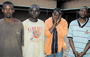 (L-R) Emmanuel Uwayisaba and Jean Baptiste Yafashije, the murder suspects, and their colleagues who were reportedly looking for clients for the victimu2019s car, at Remera Police Station, yesterday. (Photo/G. Barya)