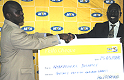 Murangwa receives the cheque from Rugege. (Courtesy photo)
