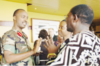 Gen. Kayonga chats with UNICEF u2018s Odera (C) and another delegate after the opening of the  conference at Hotel Novotel yesterday. (Photo/G. Barya)