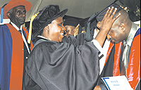 Dr Gahakwa confers a Masters degree upon a graduand yesterday, while Prof. Karangwa looks on. (Photo/G. Barya)