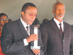 Dr Biruta blows a candle yesterday at Rebero Genocide memorial site marking the end of the official national mourning week for the victims of the 1994 Genocide. left is Francois Ngarambe. (Photo/G. Barya)