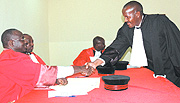 Justice Busingye (seated) congratulates Mitali Calvin upon taking the oath of office at the High Court offices in Nyamirambo, Kigali on Wednesday. (Photo/J. Mbanda).