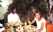 A well-spread-out table with serious diners. (Photo / P. Kayiggwa).