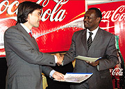 Bralirwau2019s Commercial Director Alexander Koch (L) with RVBF president Robert Bayigamba after the signing of the agreement yesterday. (Photo / J. Mbanda).