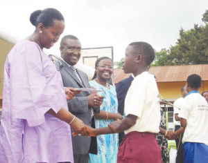 The First Lady Jeanette Kagame shakes hands with 13year old Josiane Murekatete  at the ceremony, as Ministers Thu00e9oneste Mutsindashaka and Jeanne du2019Arc Mujawamariya happily look on. (Photo /  D. Sabiiti)