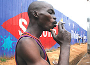 Unidentified  smoking a cigarette around KCC. ( Photo /E. Mucungunzi).