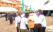 Carrying the remains of victims of the Genocide for proper burial.