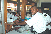 Rwanda Revenue Authority staff  attending to tax payers. (File photo) .