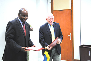 Finace minister Musoni with Ambassador MacRae after signing a $10.2 million grant to support elections. (Photo/E.Mucunguzi)