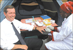 U.S. Secretary of Health and Human Services Michael O. Leavitt go on  testing for HIV at a mobile, voluntary testing site set up in Kigali.