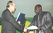 Bernard Itangishaka, the Managing Director of BPR, and Arnold Kuijpers, who represented Rabo Bank, shake hands after the partnership.
