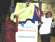 Commerce minister Minique Nsanzabaganwa (L) and Peter Nkubara, Managing Director Mutara Enterprises unveiling the new logo at Union Trade Centre in Kigali.