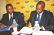 Ferwafa boss, Brig. Gen. Jean Bosco Kazura signs the agreement as MTN Rwanda Chief Executive Officer Themba Khumalo looks on.