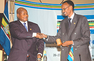President Kagame receiving the instruments of power from out-going Chairperson of the EAC, Ugandau2019s President  Yoweri Museveni.