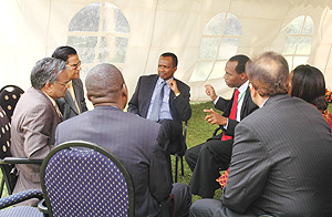 State Minister for Industry and Investment Promotion, Vincent Karega, chatting with some of the delegates at Kigali Serena Hotel. (Photo /G. Barya).