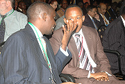 Thu00e9ogu00e8ne Turatsinze chats with Faustin Mbundu Kananura during the EAC investment conference. (Photo/G. Barya).