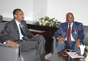 President Kagame in conversation with President Abdulaye Wade of Senegal at the AU Summit in Sharm El Sheikh, Egypt.