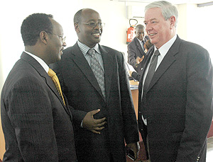 Ministers Albert Butare and James Musoni talk to David Butcher, an energy consultant, after signing the MOU. (Photo / J. Mbanda).