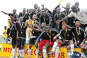 Goal scorer Hegman Ngoma (with trophy) leads APR players in celebrating their Peace Cup win yesterday. (Photo / G. Barya).