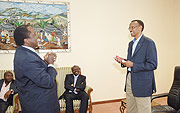 President Kagame receives a book from Mugo Kibati, former chief executive of East Africa Cables during a courtesy call by a group of Kenyan professionals who have formed an investment vehicle based in Rwanda. (PPU photo).