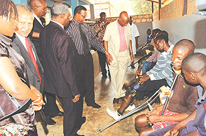 The Minister of Defence, Gen. Marcel Gatinzi (black suit) with members of the Rotary club tour Kanombe Military Hospital. (Photo/G.Barya).