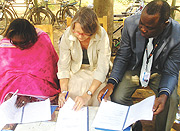 CEO Rwanda Flora, Beatrice Gakuba (L), WFP Rwanda representative, Maarit Hirvonen(C) and UNFPA Program Advisor, Florentin Donadje sign the agreement. (Photo/G. Barya).