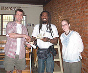 One Love Project coordinator, Gatera Rudasingwa receive funds from MBCBC coordinators Darryl R. Towers and Meredith Daun.(File photo)