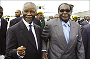 South African president Thabo Mbeki hand in hand with Zimbabweu2019s Robert Mugabe.