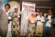 Bill Clinton (C) tastes coffee with farmers, the State Minister of Agriculture Agnes Kalibata (far left) and Director General Ocir-cafe Alex Kanyakole (Photo/G.Barya)