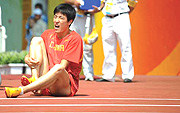 Chinau2019s Liu Xiang reacts after getting injured. (Photo/ Li Ga/ Xinhua).