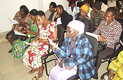 KNOWLEDGE IS POWER Some of the Business women who will undergo training in Entrepreneurship and Management, read course guidelines at SFB. (Photo J. Buyinza).