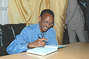 President Paul Kagame signs a visitoru2019s at Gikondo Expo Grounds in Kigali in 2006. The President is expected to open exhibion. (File photo).