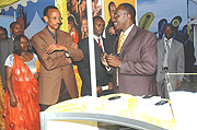 MTNu2019s Chief Operation Officer Andrew Rugege  (L) shows President Paul Kagame the recently introduced ZTE phone commonly known as Karasharamye during the opening of the 11th Expo at Gikondo. (Photo/ G. Barya).
