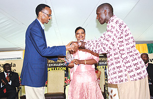 WELL DONE: President Paul Kagame handing over a trophy to the best coffee farmer at the Cup Of Excellence awards. (Photo PPU).