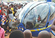 Akagera Aviation helicopter at Gikondo show ground. Many show goers wait to have fun flights. (Photo/G.Barya).