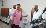 ENVIROMENTALLY FRIENDLY: KCCu2019s in charge of Social Affairs, Jeanne du2019Arc Gakuba (C) shows the media and public the inside of the Eco-toilet. (Photo G.Barya).
