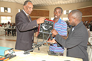 GOOD LUCK: Former RDF soldier, Protegene Buramba (C) receives a welding machine from the Executive Secretary RDRC, Jean Sayinzoga (L) to help him in his civilian life. (Photo G.Barya).