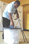 CIVIC DUTY, a disabled student from Gatagara Secondary School casts his ballot at Butare Catholic polling station. ( Photo/ P.Ntambara).